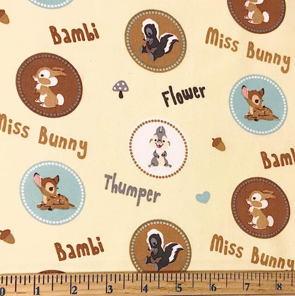 Bambi & Friends Badges On Pale Yellow Cotton Fabric